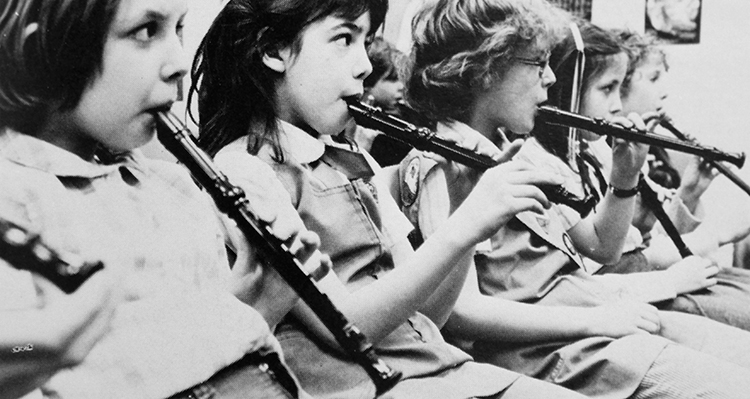 Black and white photograph of students playing recorders.