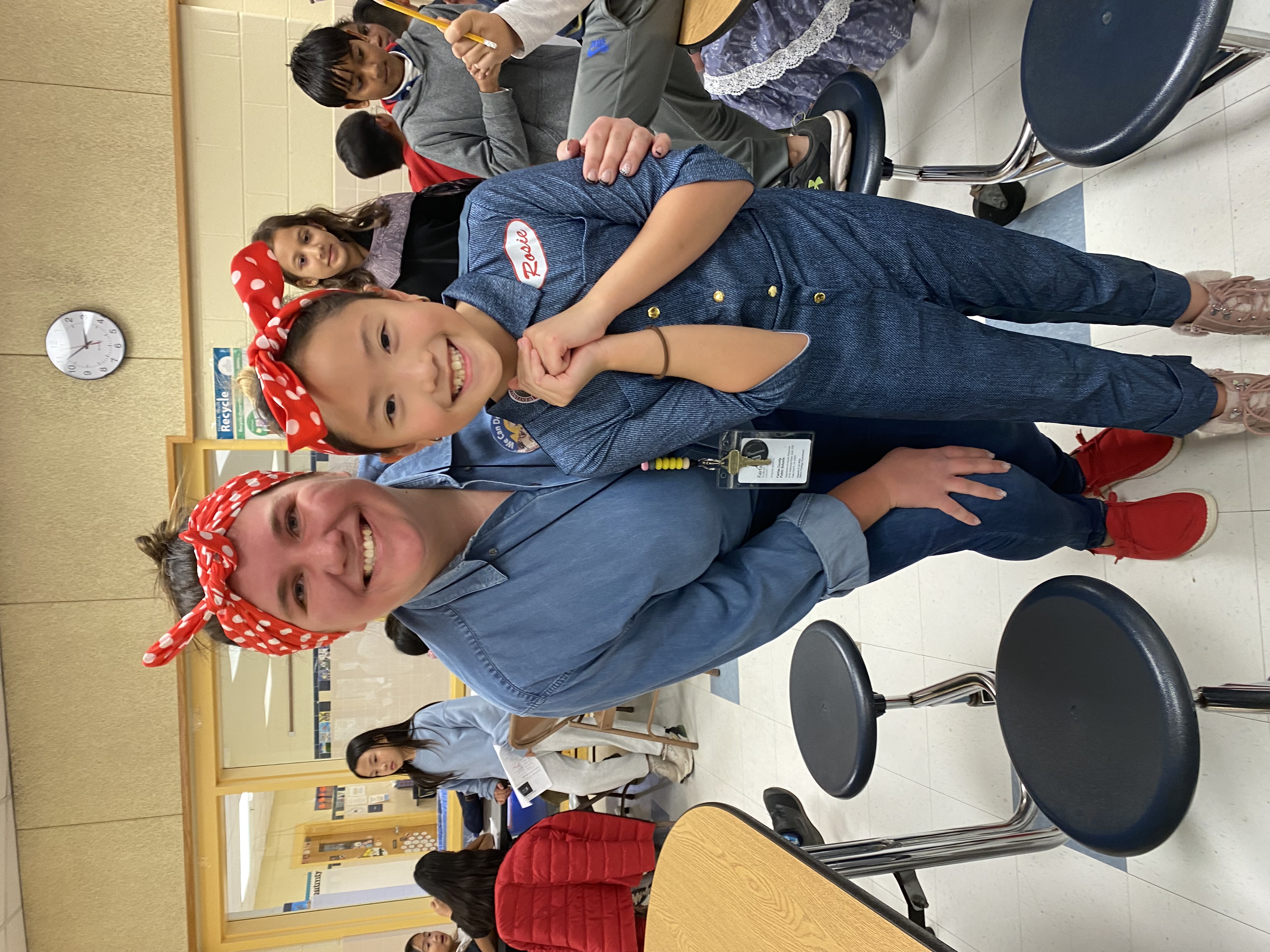 Ms. Kelly and a student both dressed as Rosie the Riveter